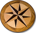 This compass rose out of solid wood lies in the top of an oval table J.T. John designed for a yacht based in Washington. It features Peruvian walnut, quilted maple, and “figured” teak, all in a field of teak.