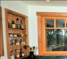 Tight space in this Topanga, California kitchen was maximized by cherry storage boxes built into the walls, as on a ship. Topanga, California kitchen photos by Peter R. Taft Photography.