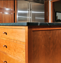 The island was designed to maximize work space and storage, while accommodating an antique butcher block, which Northbeach completely refurbished.