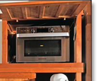The tansu provides ample storage and work space, all in a beautiful alternative to an ordinary wall of upper and lower cabinets with an appliance-cluttered countertop.