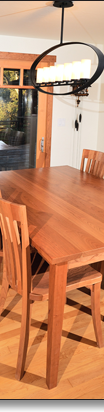 J.T. designed this cherry dining table, which normally seats six but can accommodate up to ten. Table and chairs available separately, and in other woods.