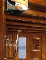 Teak dining table J.T. John created to match existing design elements elsewhere on the yacht,  including radiused corners and lamb's tongue details. Photo by Neil Rabinowitz; yacht restoration by Tom George.
