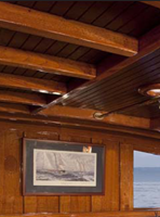 Teak dining table J.T. John created to match existing design elements elsewhere on the yacht,  including radiused corners and lamb's tongue details. Photo by Neil Rabinowitz; yacht restoration by Tom George.