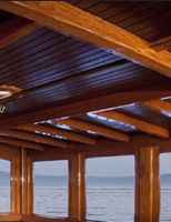 Teak dining table J.T. John created to match existing design elements elsewhere on the yacht,  including radiused corners and lamb's tongue details. Photo by Neil Rabinowitz; yacht restoration by Tom George.