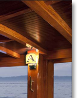 Teak dining table J.T. John created to match existing design elements elsewhere on the yacht,  including radiused corners and lamb's tongue details. Photo by Neil Rabinowitz; yacht restoration by Tom George.