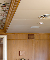 Curved media storage and matching settee and table pedestal in oak, which J.T. John designed for the same Washington based yacht.
