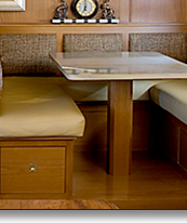 Curved media storage and matching settee and table pedestal in oak, which J.T. John designed for the same Washington based yacht.