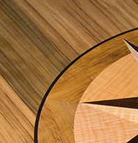 This compass rose out of solid wood lies in the top of an oval table J.T. John designed for a yacht based in Washington. It features Peruvian walnut, quilted maple, and “figured” teak, all in a field of teak.