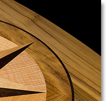 This compass rose out of solid wood lies in the top of an oval table J.T. John designed for a yacht based in Washington. It features Peruvian walnut, quilted maple, and “figured” teak, all in a field of teak.