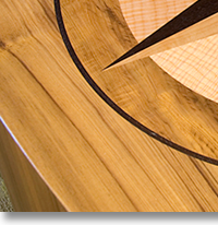 This compass rose out of solid wood lies in the top of an oval table J.T. John designed for a yacht based in Washington. It features Peruvian walnut, quilted maple, and “figured” teak, all in a field of teak.