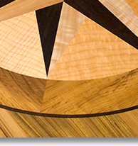 This compass rose out of solid wood lies in the top of an oval table J.T. John designed for a yacht based in Washington. It features Peruvian walnut, quilted maple, and “figured” teak, all in a field of teak.