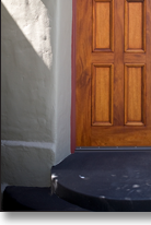Arched mahogany front door, designed by J.T. John for a Los Angeles, California home, after considerable research into the original design features of the 1920's house and neighborhood.