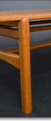 Cherry coffee table designed by J.T. John.