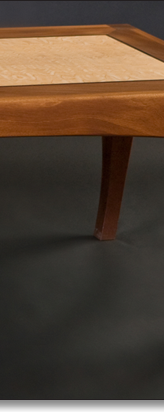 Coffee table designed by J.T. John in western maple and mahogany.