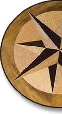 This compass rose out of solid wood lies in the top of an oval table J.T. John designed for a yacht based in Washington. It features Peruvian walnut, quilted maple, and “figured” teak, all in a field of teak.